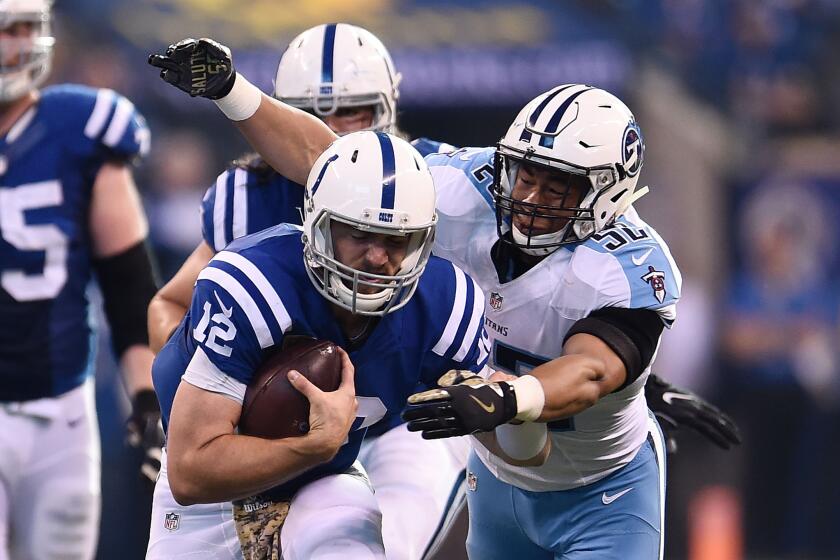 Colts quarterback Andrew Luck (12) is brought down by Titans linebacker Aaron Wallace (52) during the first half on Nov. 20.