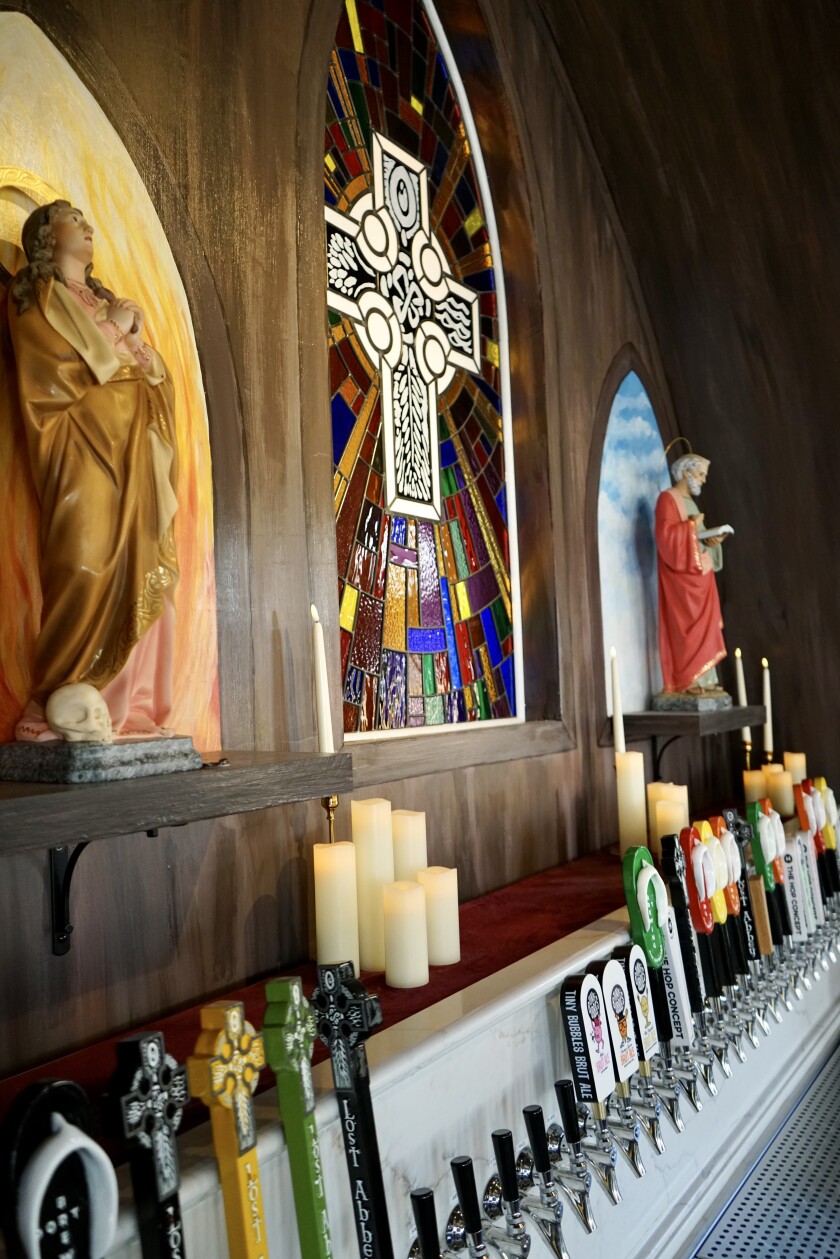 Above the 31 tap handles are two religious statues from Italy, as well as a stained glass by local artist Paul Bloomquist