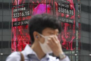 A person walks in front of an electronic stock board showing Japan's Nikkei 225 index at a securities firm Friday, June 23, 2023, in Tokyo. Asian shares sank sharply Friday after several central banks around the world cranked interest rates higher in their fight against inflation.(AP Photo/Eugene Hoshiko)