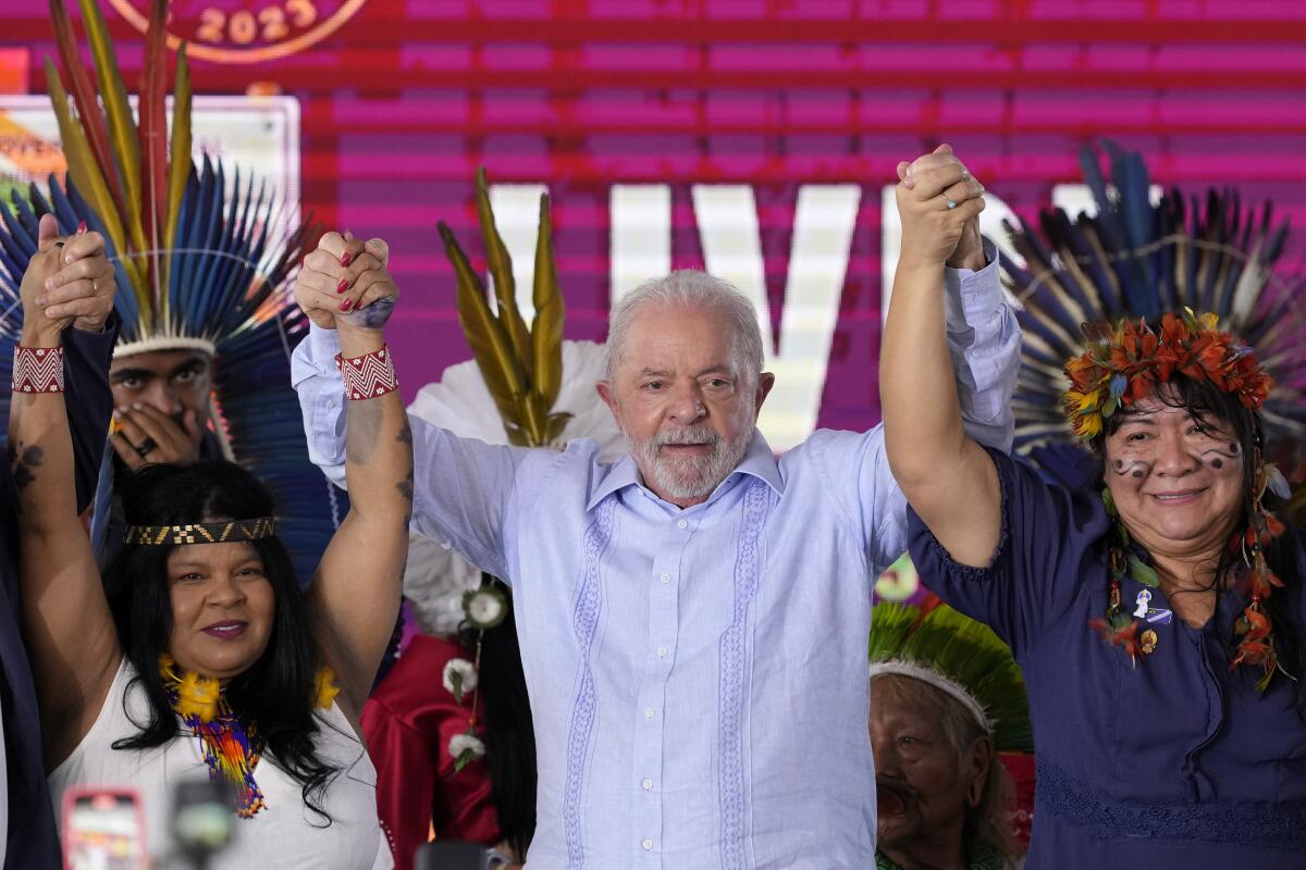 Brazilian President Luiz Inacio Lula da Silva, with the Indigenous Peoples minister and an advocate for Indigenous rights. 