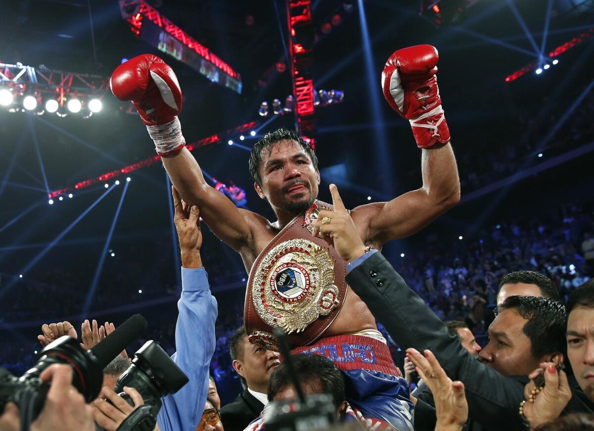 Manny Pacquiao celebrates his victory over Brandon Rios in a WBO welterweight title fight in Macau, China, on Sunday. Pacquiao's next fight could take place in Las Vegas in April.