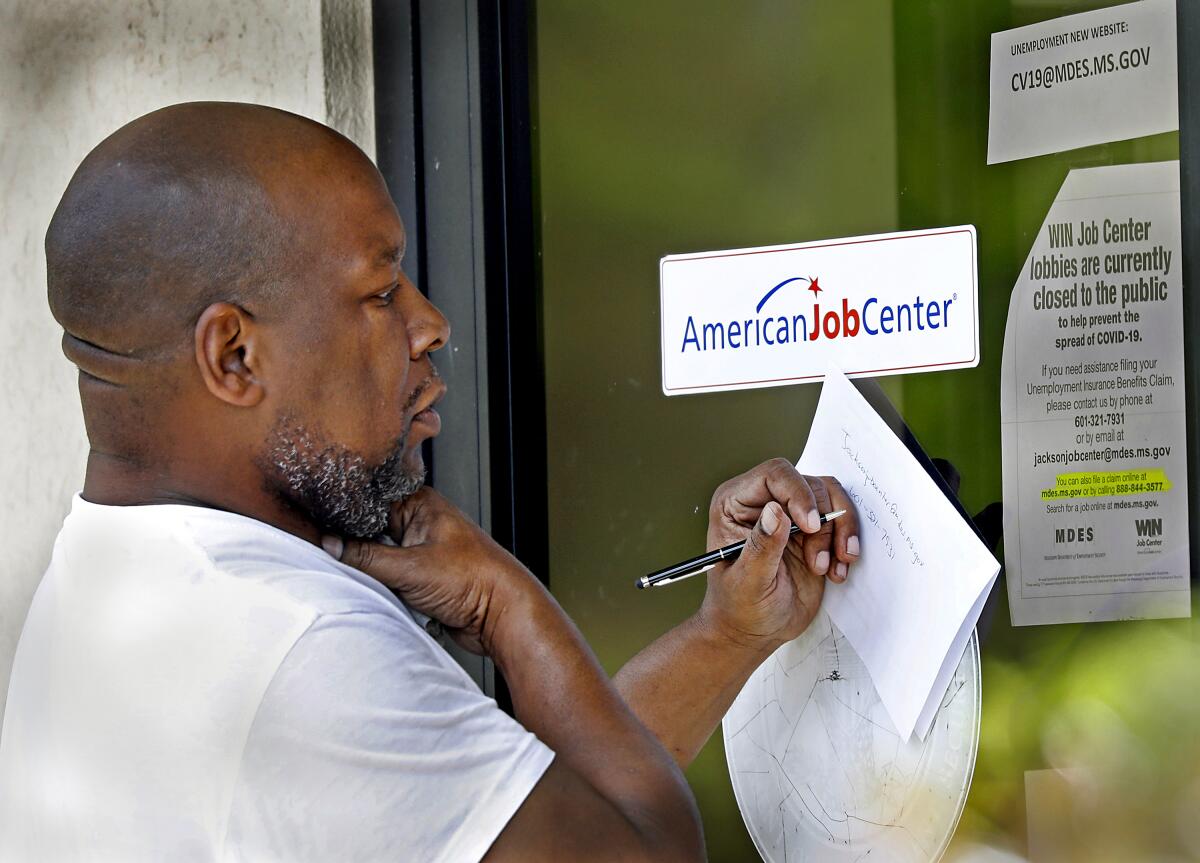A resident copies down the Mississippi unemployment benefit website.
