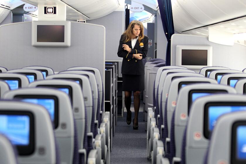 Flight attendant Tonya Johnson walks the aisles of United Airlines' 787 Dreamliner at LAX. A union for flight attendants is calling for better screening procedures to protect against the spread of Ebola.