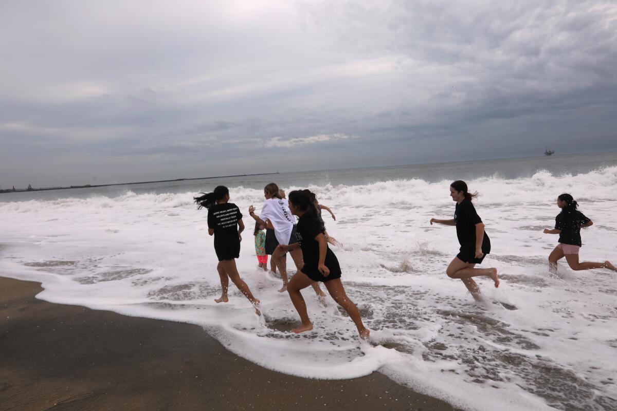 Teenage girls running on the beach