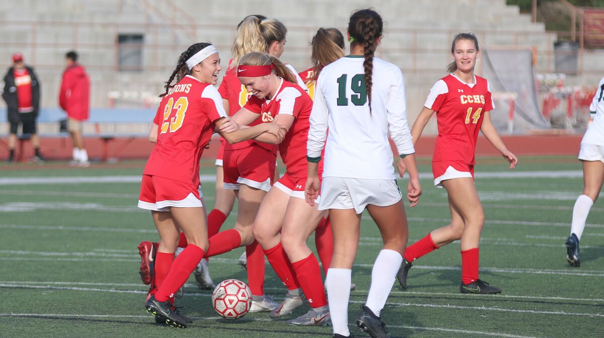Cathedral junior Caylee Hornaday (23) is greeted by teammates after scoring Thursday's first goal.