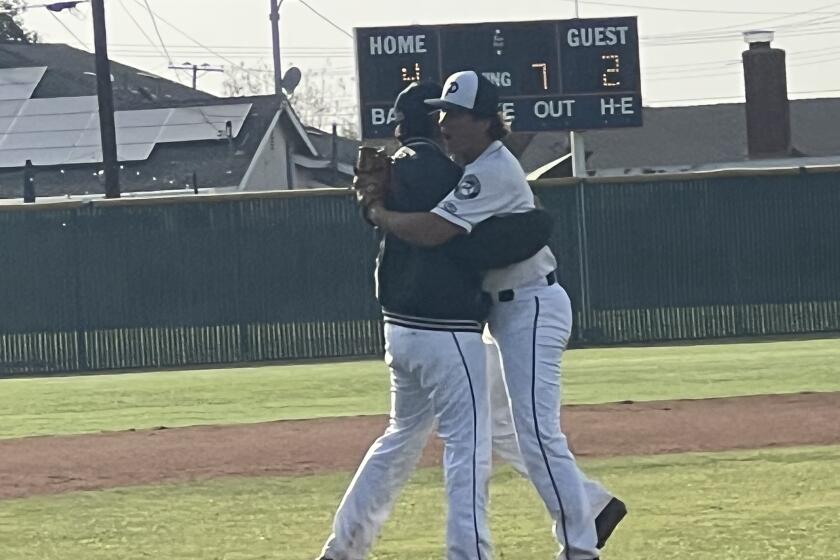 Relief pitcher Chad Gurnea (right) embraces starting pitching Logan Brady after Pacifica's 4-2 win over Cypress.