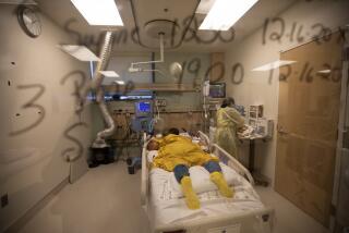 LOS ANGELES, CA - DECEMBER 17: During the coronavirus pandeimic Michelle Goldson, RN is working with a covid positive patient inside the ICU at Martin Luther King, Jr. Community Hospital on Thursday, Dec. 17, 020 in Los Angeles, CA. ICU availability in Southern California at 0% amid deluge of COVID-19 patients. (Francine Orr / Los Angeles Times)