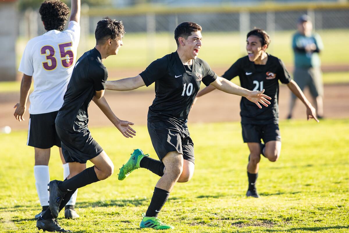 Los Amigos' Arturo Mota, center, celebrates after scoring a goal against Esperanza on Friday.