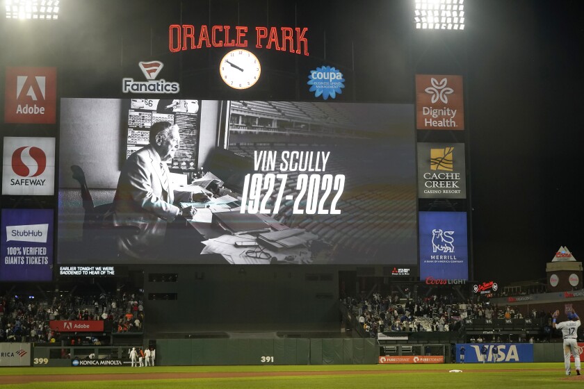 An image on a scoreboard reads "Vin Scully: 1927-2022."