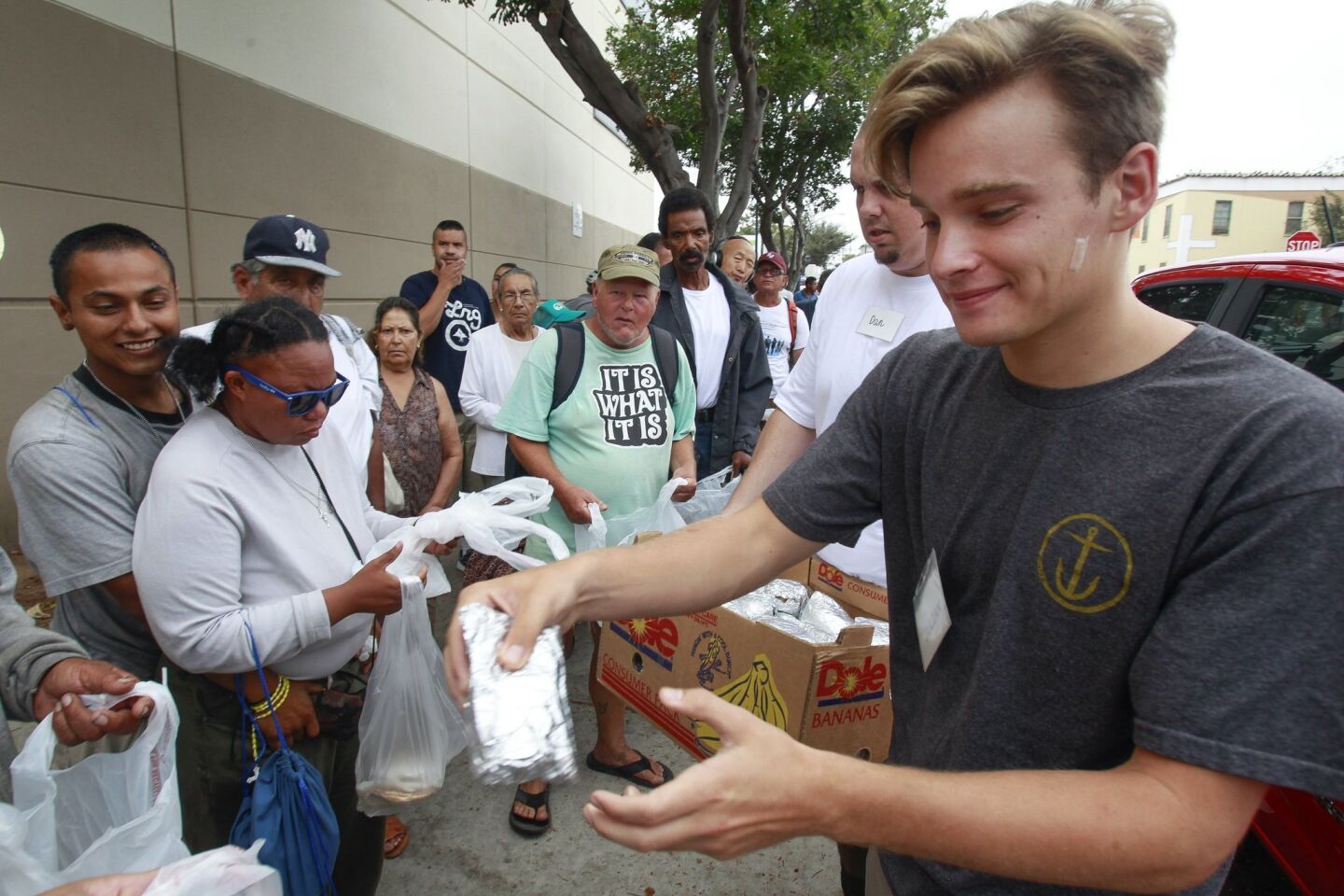 Burrito Boyz member Julian Wahl,18, hands egg burritos out to people, most of them homeless, in downtown San Diego.