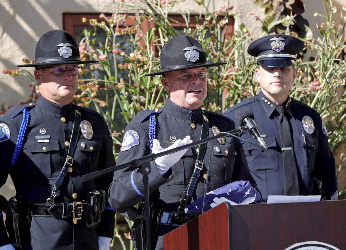 Sgt. David McGill, center, is honored for his exemplary duties on the Laguna Beach honor guard.