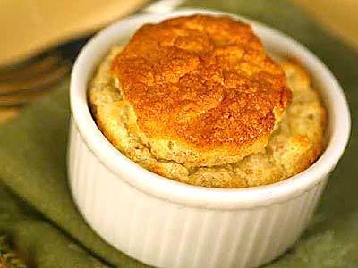 Goat cheese adds a tangy undercurrent to the earthy flavor of walnuts in this do-ahead soufflé.