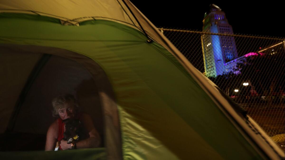Tamela Kerneghan, 52, sets up her tent near Los Angeles City Hall. A pest control company warned that the homeless created “harborage for rodents.”