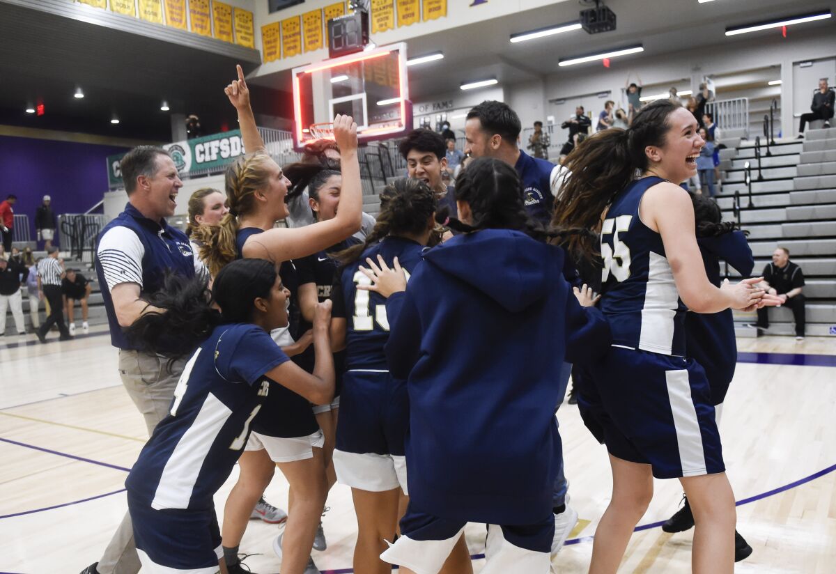 St. Joseph Academy players celebrate after beating Fallbrook 45-44 in the division III 