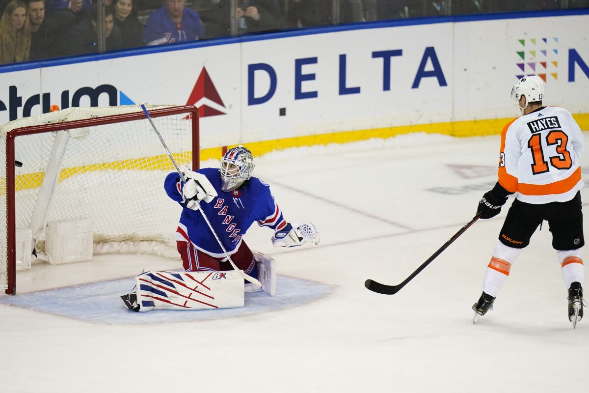 Philadelphia Flyers' Kevin Hayes (13) shoots the puck past New York Rangers goaltender Igor Shesterkin (31) for a goal during the shootout of an NHL hockey game Sunday, April 3, 2022, in New York. The Flyers won 4-3. (AP Photo/Frank Franklin II)