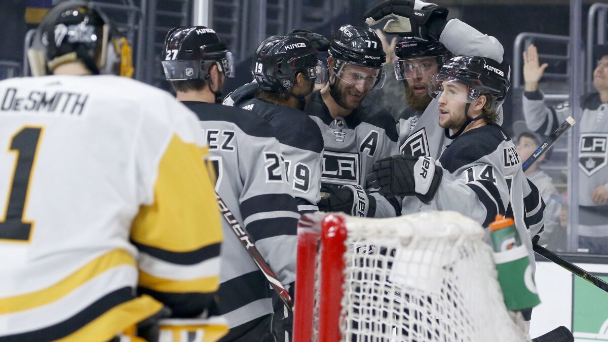 Kings players celebrate a goal against the Penguins during the second period Saturday.