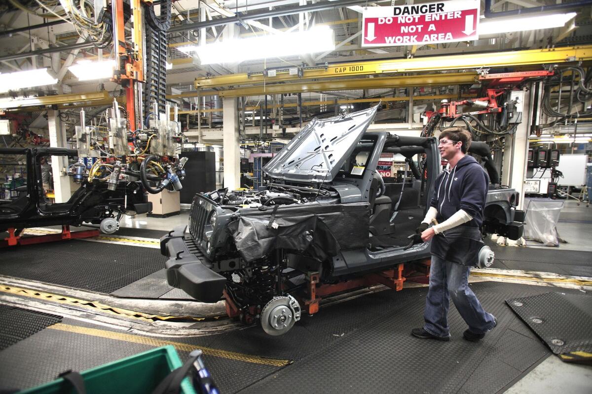 A 2014 Jeep Wrangler is assembled at a Chrysler plant in Toledo, Ohio, last month.
