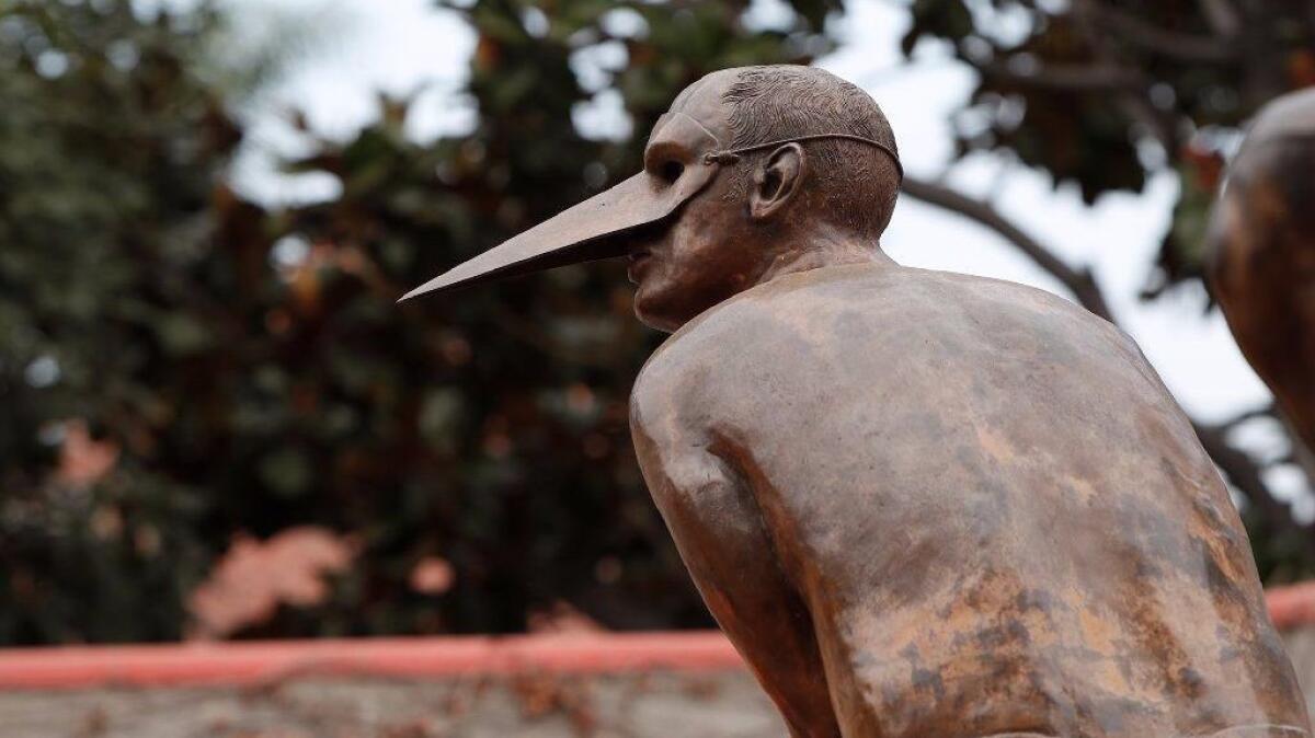 The bird-masked bronze sculpture "Split Monumental" is one of nine artworks by Mexican figurative artist Jorge Marín that will be part of a public art installation, "Wings of the City," in downtown Santa Ana.