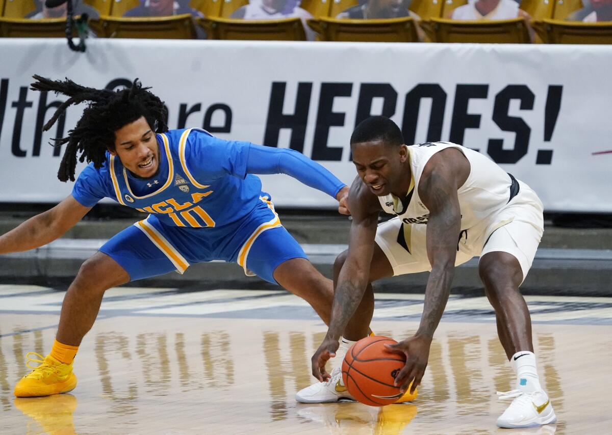 UCLA guard Tyger Campbell, left, pressures Colorado guard McKinley Wright IV.