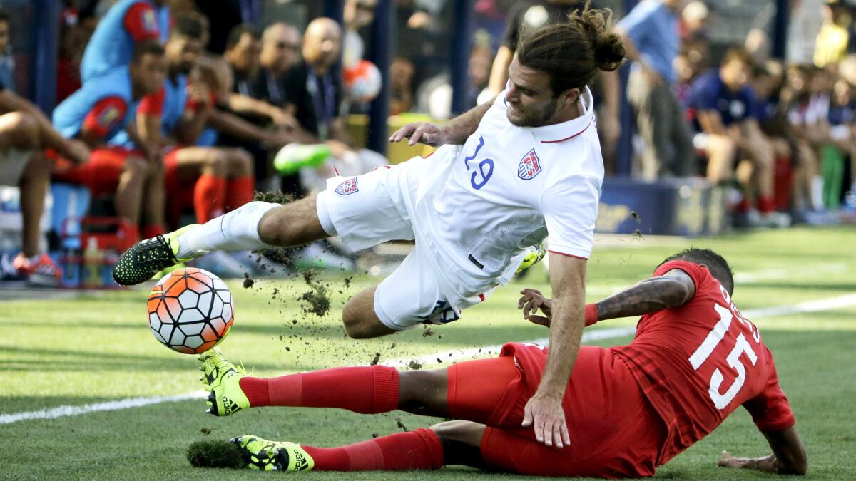 U.S. midfielder Graham Zusi (19) is tripped up by the tackle of Panama defender Erick Davis (15) in the first half of the CONCACAF Gold Cup third-place game on Saturday.