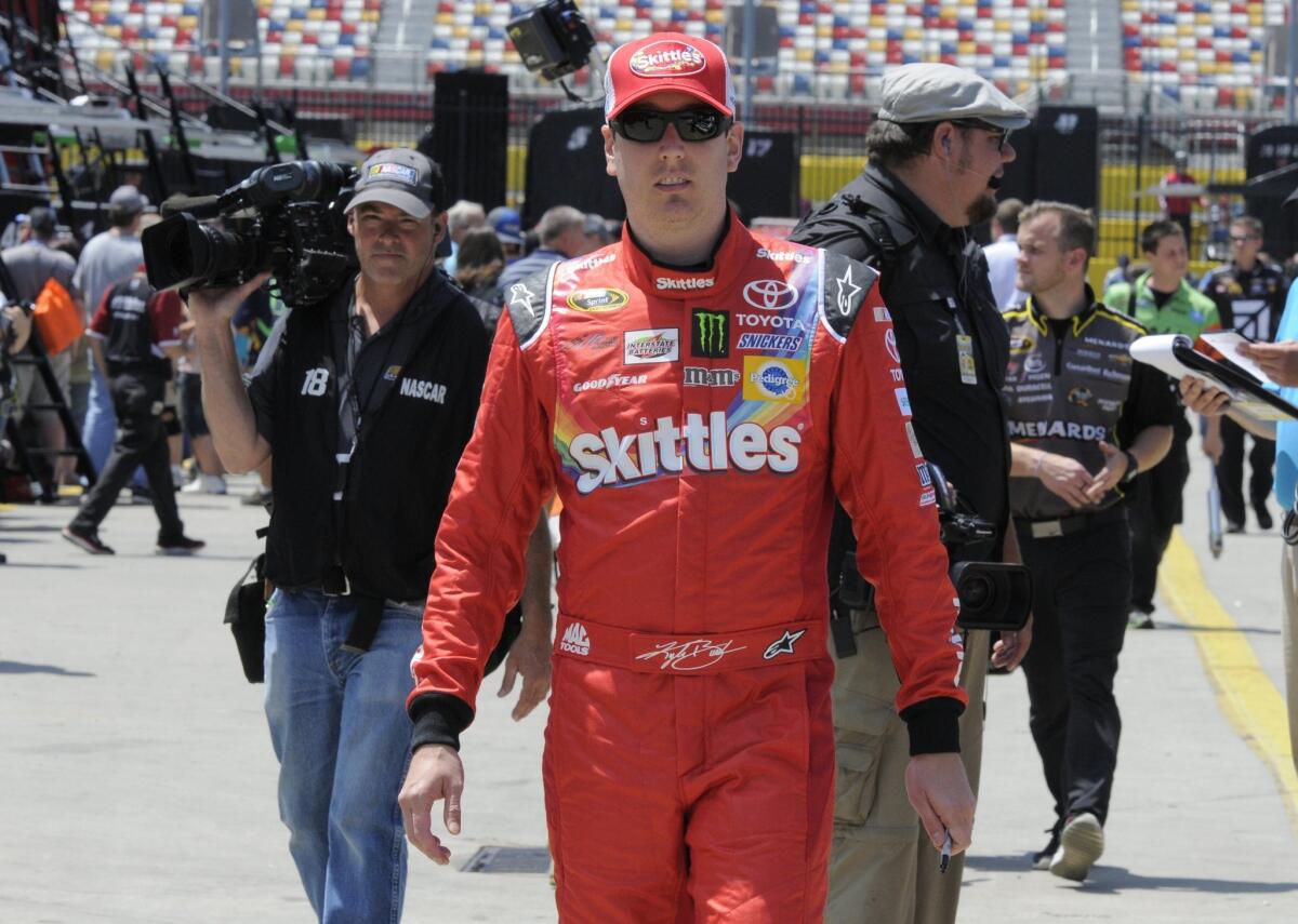 Kyle Busch walks through the garage Thursday before practice for the Coca-Cola 600 at Charlotte Motor Speedway.