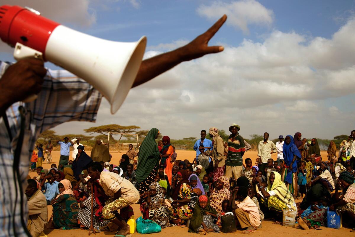 In 2009, newly arriving refugees, mostly Somalis, crowd into a line to be admitted into Dadaab, the largest refugee camp in the world.