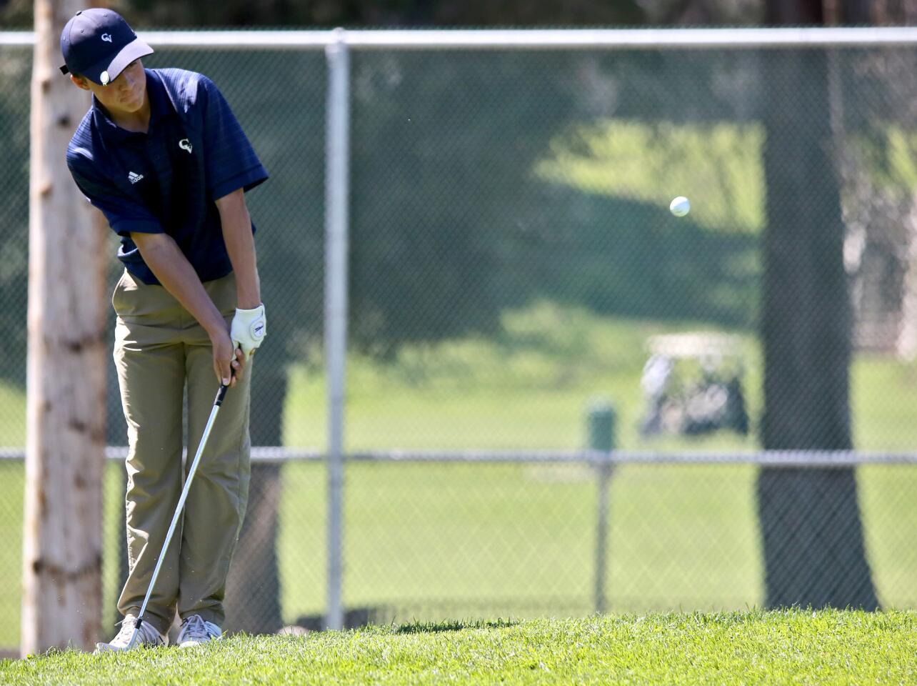 Crescenta Valley High School freshman Hank Norman makes par with a 35-yard chip into the cup from outside the green, in the second hole of Pacific League play at Harding Golf Course in Los Angeles on Thursday, March 14, 2019.