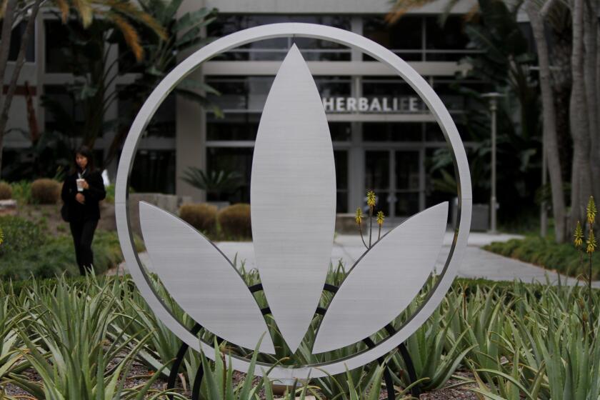 The Herbalife logo is mounted in a garden of aloe plants at company headquarters in Torrance.