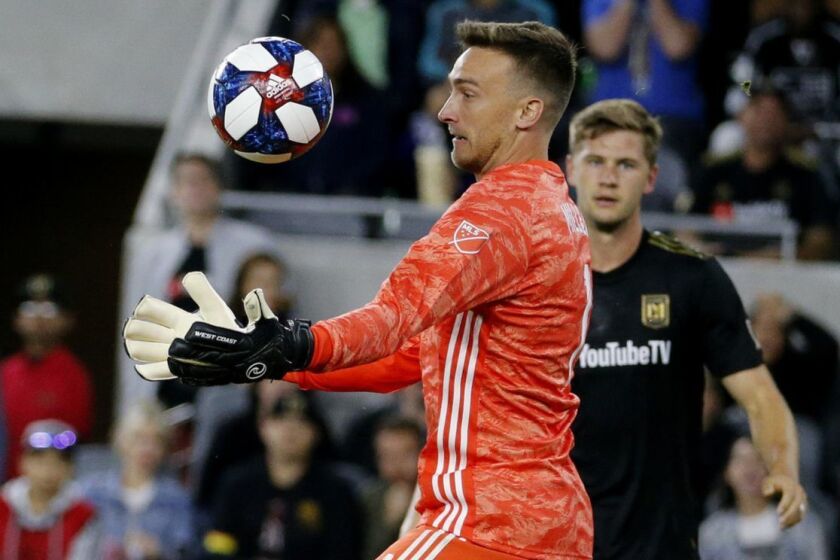 Los Angeles FC goalkeeper Tyler Miller (1) makes a save against Montreal Impact midfielder Shamit Shome (28) in an MLS soccer match between Los Angeles FC and Montreal Impact in Los Angeles, Friday, May 24, 2019. LAFC won 4-2. (AP Photo/Ringo H.W. Chiu)
