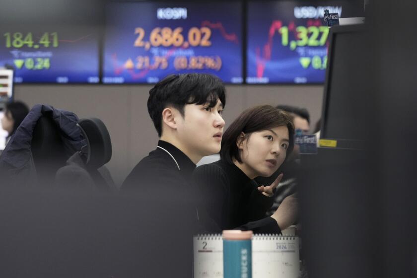 Currency traders watch monitors at the foreign exchange dealing room of the KEB Hana Bank headquarters in Seoul, South Korea, Friday, Feb. 23, 2024. Asian markets mostly gained on Friday after Nvidia delivered another blowout quarter, setting off a rally in other technology companies that carried Wall Street to another record high. (AP Photo/Ahn Young-joon)