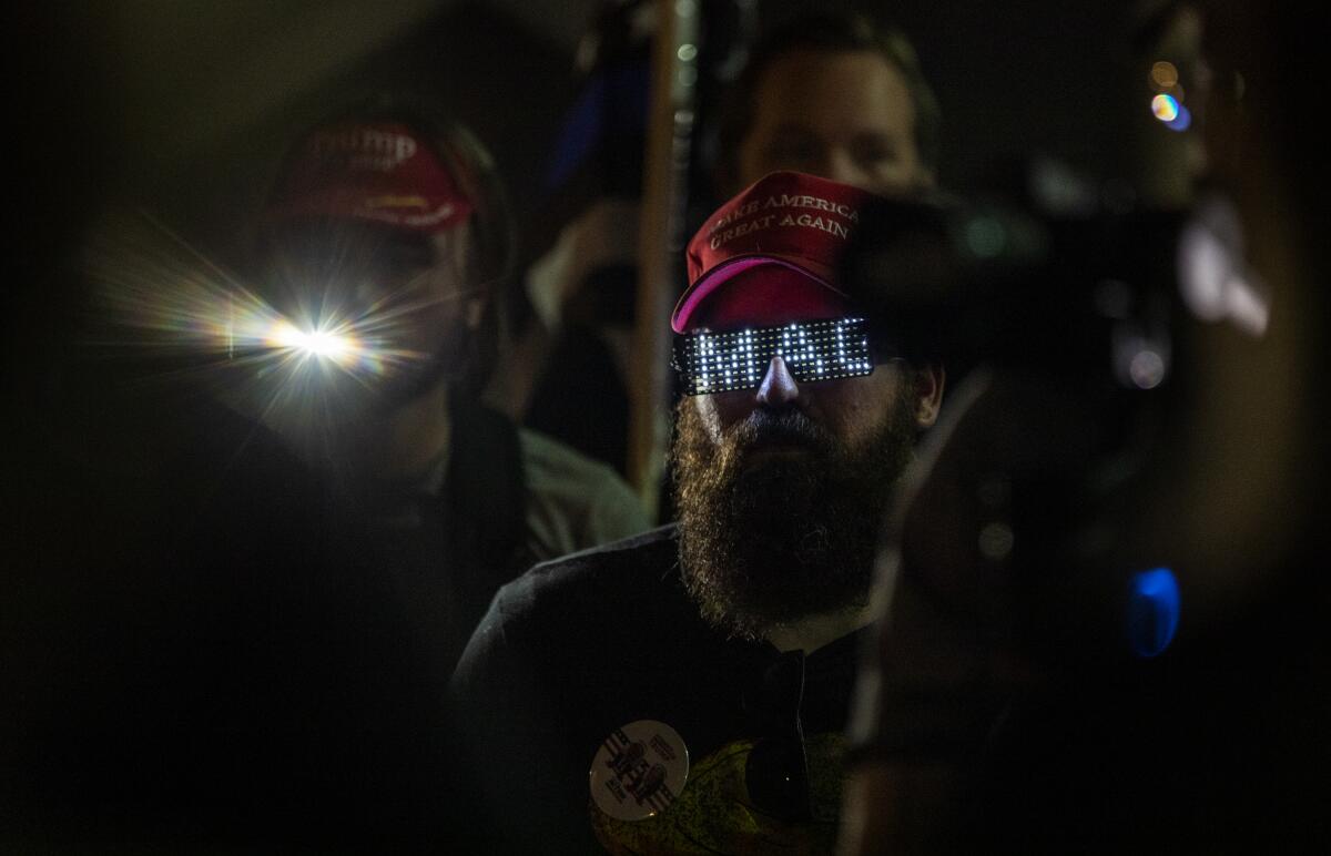 Supporters of President Trump protest Thursday outside the Maricopa County elections building in Phoenix.