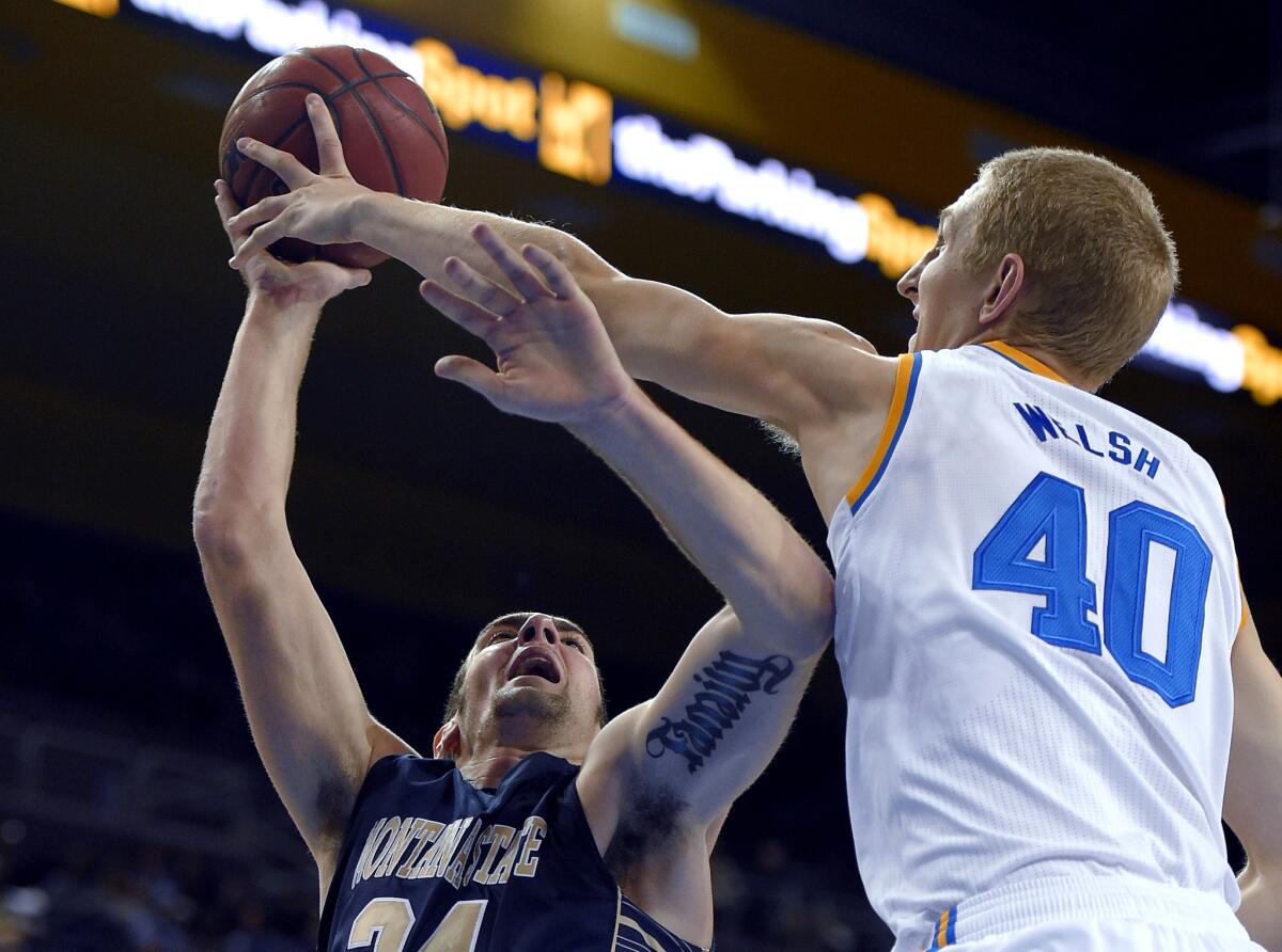 UCLA center Thomas Welsh blocks a shot by Montana State forward Danny Robison in the first half Friday night.