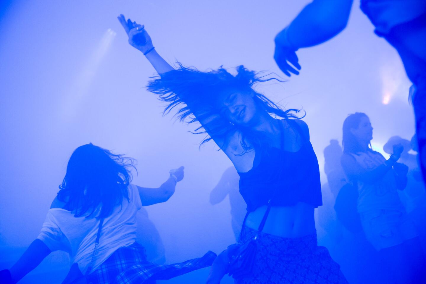 A music fan flings her hair to the beats of EDM music during Week 2 of the Coachella Valley Music and Arts Festival, 2015.