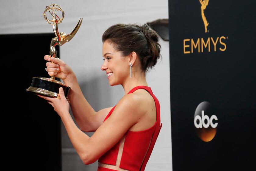 Tatiana Maslany holds up her Emmy Award for lead actress in a drama series.