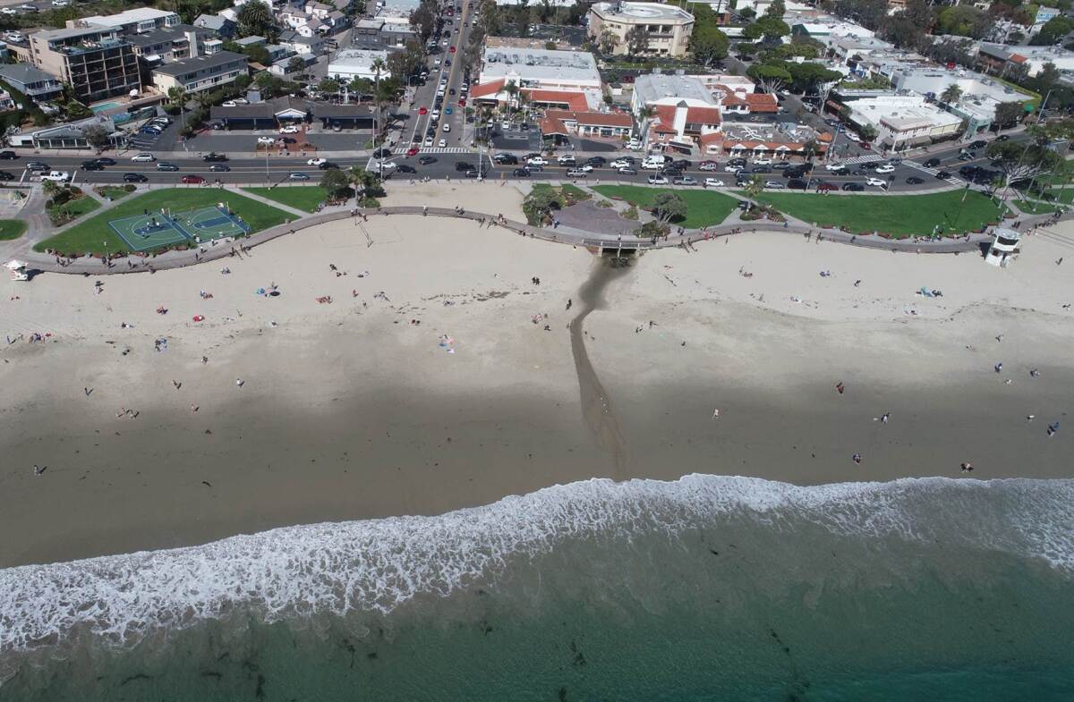 An aerial photo shows Main Beach in Laguna Beach at about 3 p.m. Saturday. The city is closing its beaches and adjacent parks, including Main Beach, in hopes of preventing crowding and curbing the spread of the COVID-19 coronavirus.