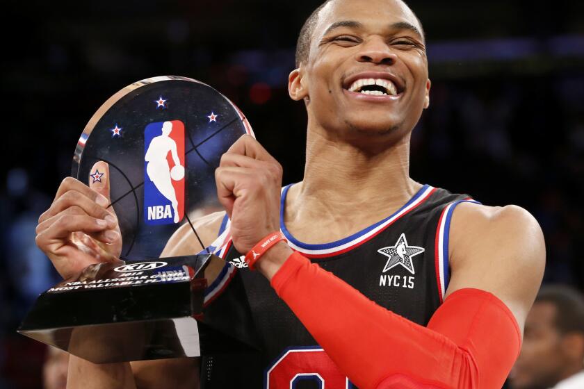 Thunder point guard Russell Westbrook poses with the MVP trophy after leading the West to a 163-158 victory over the East with 41 points, the second most in an NBA All-Star game.