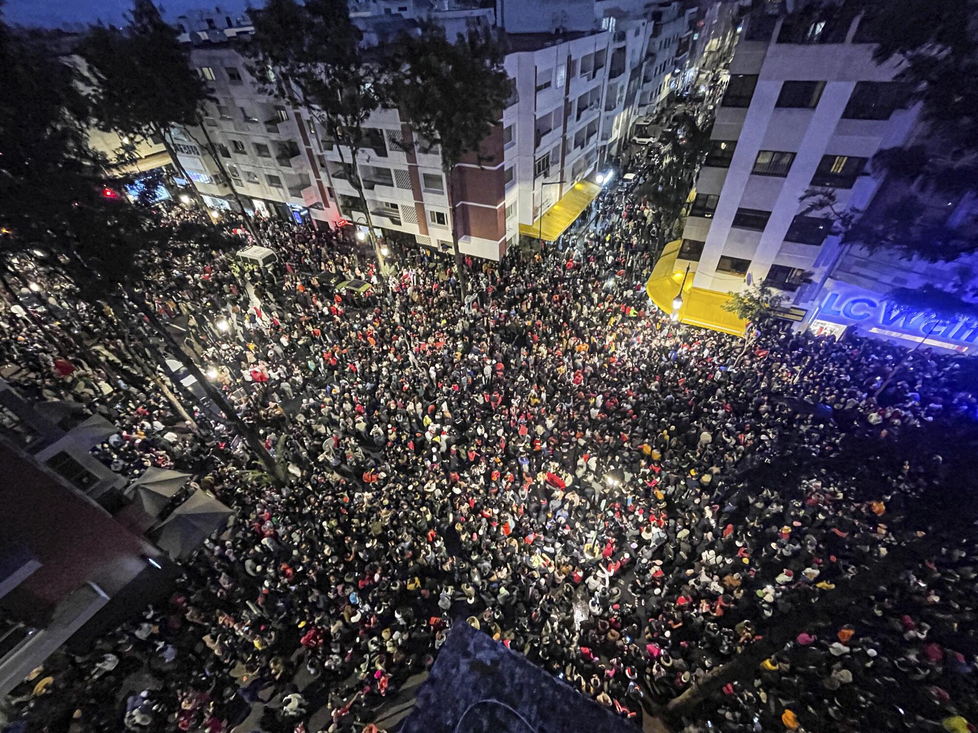 Fans in in Rabat, Morocco, celebrate after their national team beat Canada 2-1 and qualified to the World Cup knockout stage