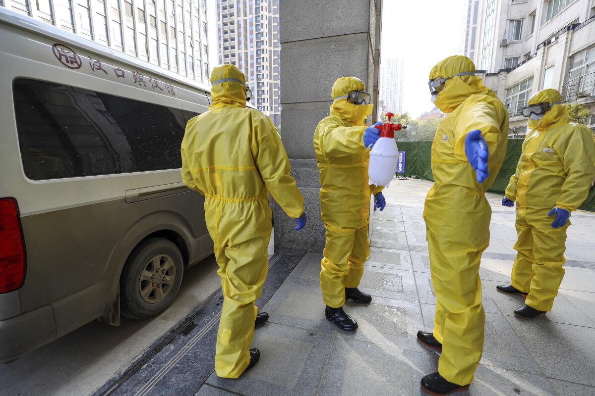 Funeral workers disinfect themselves after handling a coronavirus victim in Wuhan, China.