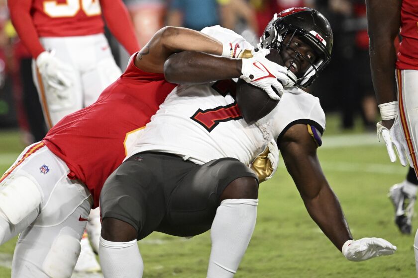 Tampa Bay Buccaneers running back Leonard Fournette (7) is taken down a Kansas City Chiefs defender during the second half of an NFL football game Sunday, Oct. 2, 2022, in Tampa, Fla. (AP Photo/Jason Behnken)