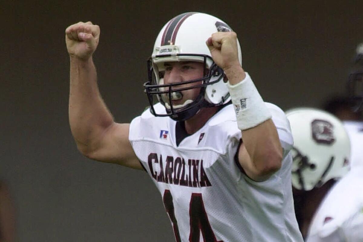 FILE - South Carolina quarterback Phil Petty (14) celebrates after the Gamecocks scored against Vanderbilt on an Andrew Pinnock run on Saturday, Oct. 21, 2000, in Nashville, Tenn. South Carolina defeated Vanderbilt, 30-14. Petty, who led Lou Holtz's teams to two Outback Bowl wins has died at age 43. The school announced Petty's death on Thursday, July 21, 2022.(AP Photo/Mark Humphrey, FIle)