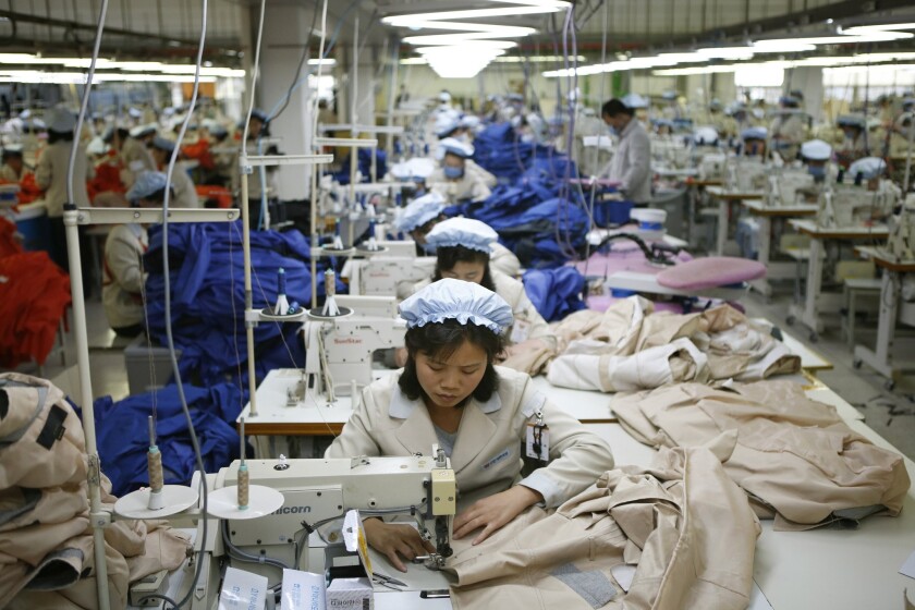 North Korean workers assemble jackets at a factory of a South Korean-owned company at the jointly run Kaesong Industrial Complex in North Korea in 2013. South Korea shut the park down in 2016.