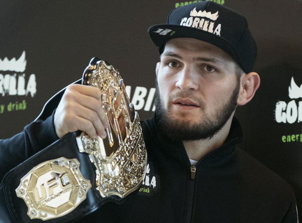 UFC lightweight champion Khabib Nurmagomedov holds the trophy belt during a news conference in Moscow, Russia.