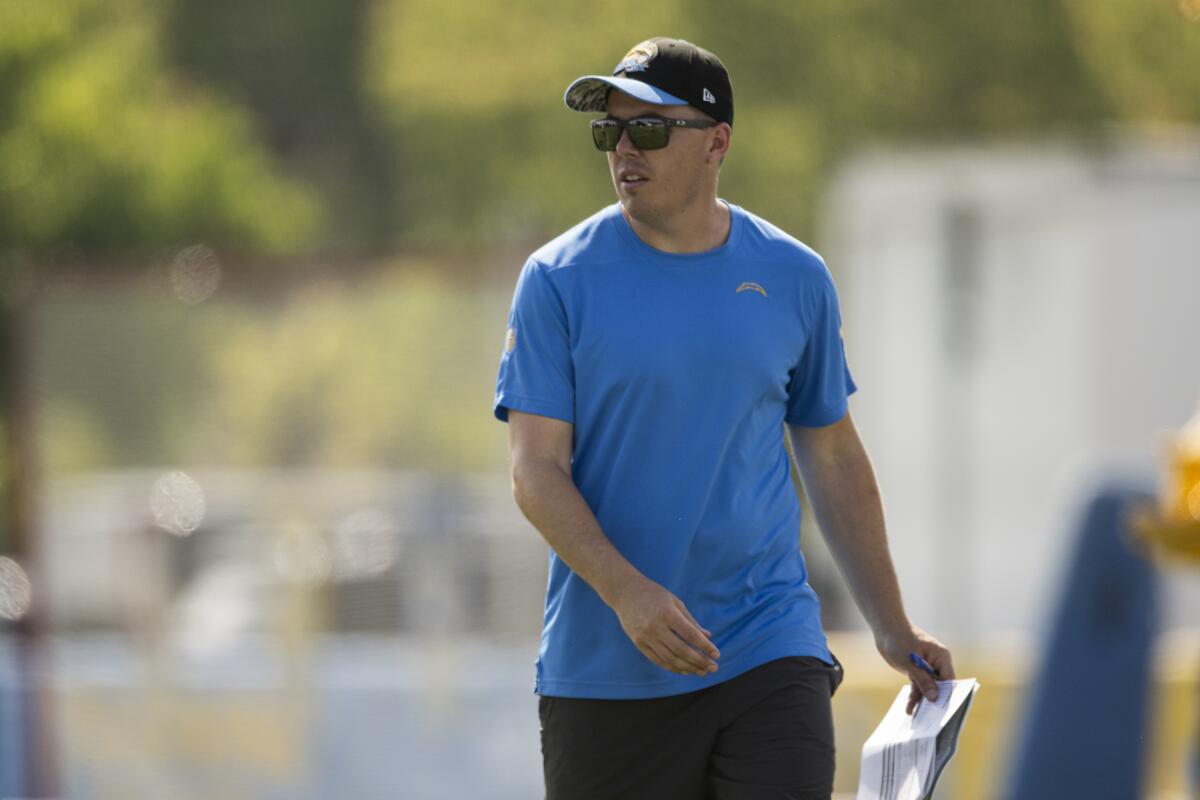 Chargers offensive coordinator Kellen Moore watches his players during training camp in July.