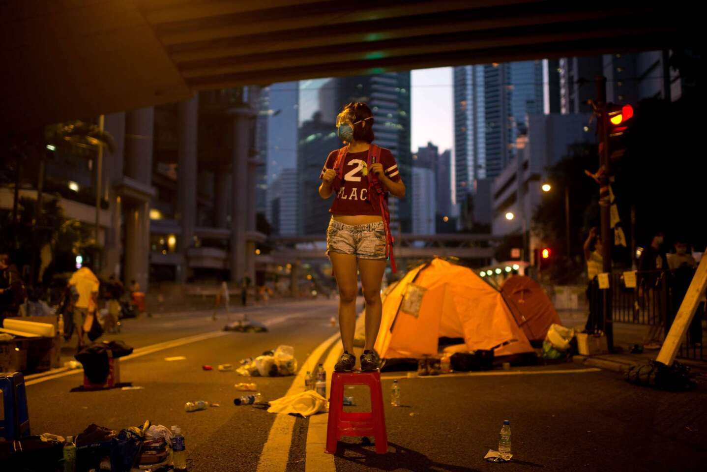 A pro-democracy protester in the Admiralty district of Hong Kong, where police started removing street barricades at sites where demonstrators have been holding rallies, paralyzing parts of the Chinese financial hub.