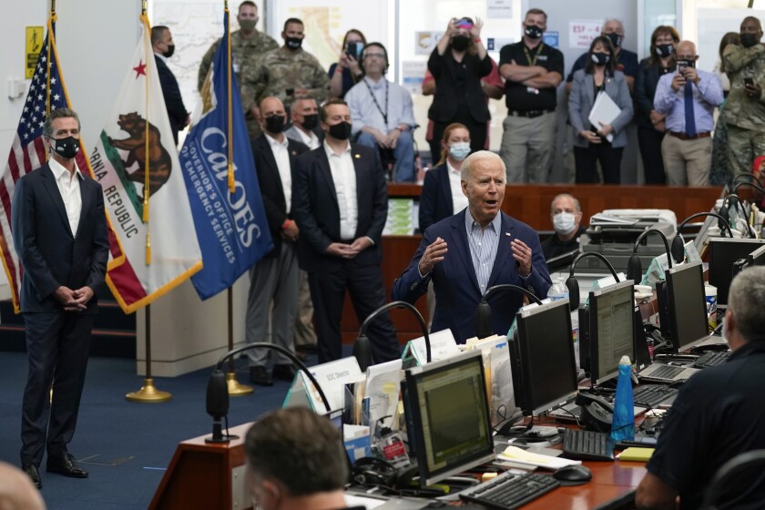 President Biden speaks to people seated at computers
