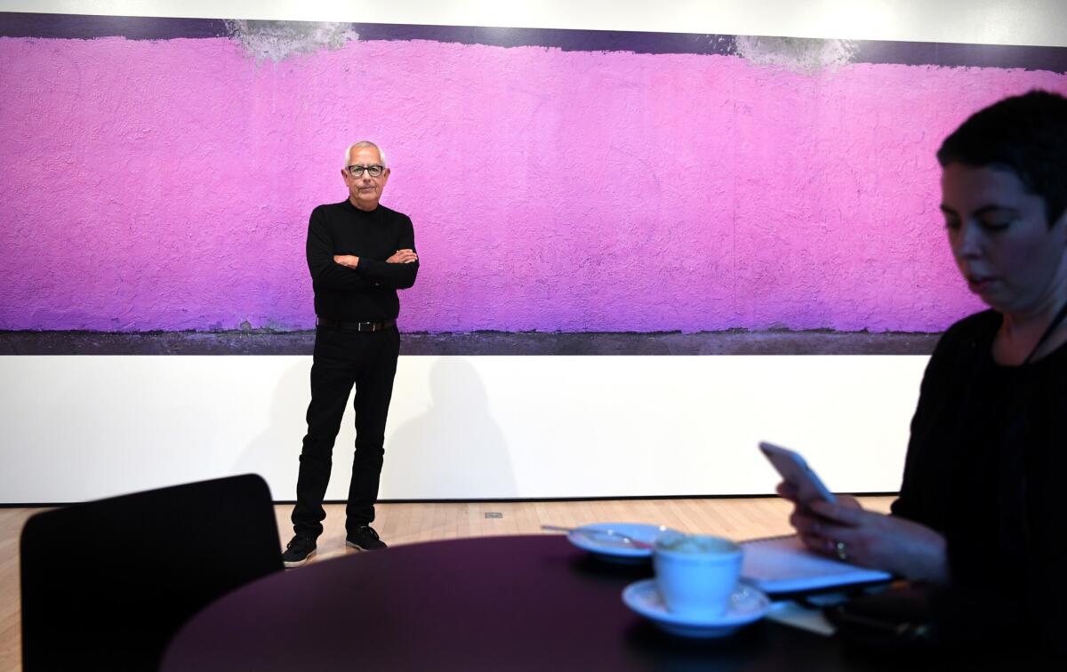 Anthony Hernandez stands before his mural-sized print "South Central," 2015, at SFMOMA.