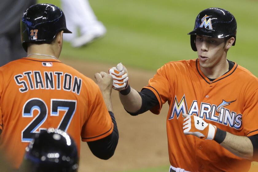 Miami's Christian Yelich, right, is congratulated by Giancarlo Stanton after hitting a home run during the fifth inning of the Dodgers' 5-4 loss Sunday.