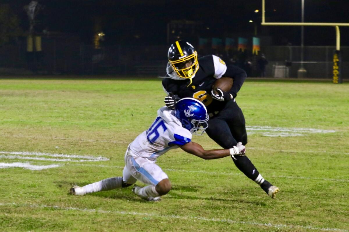 San Pedro wide receiver Dejuan Bullard is tackled by Palisades cornerback Amari Yolas.