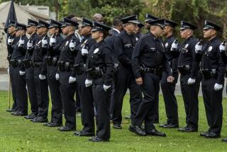 LOS ANGELES, CA-JUNE 2, 2023: LAPD Chief of Police Michel Moore, center, and LAPD Captain Christopher Zine, to his immediate right, conduct a uniform inspection during the graduation ceremony for the Los Angeles Police Academy Class 12-2022 at the Los Angeles Police Academy in Los Angeles. (Mel Melcon / Los Angeles Times)