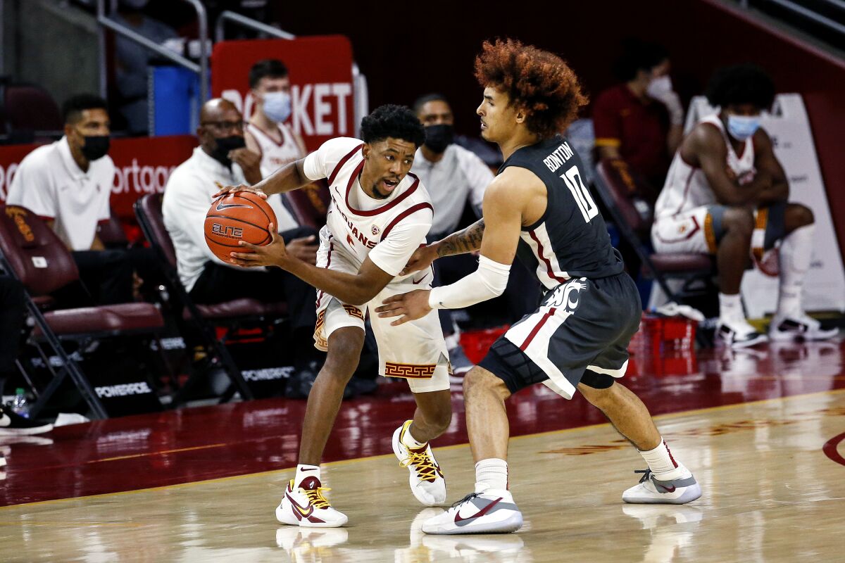 USC's Tahj Eaddy is defended by Washington State's Isaac Bonton on Jan. 16, 2021, in Los Angeles.
